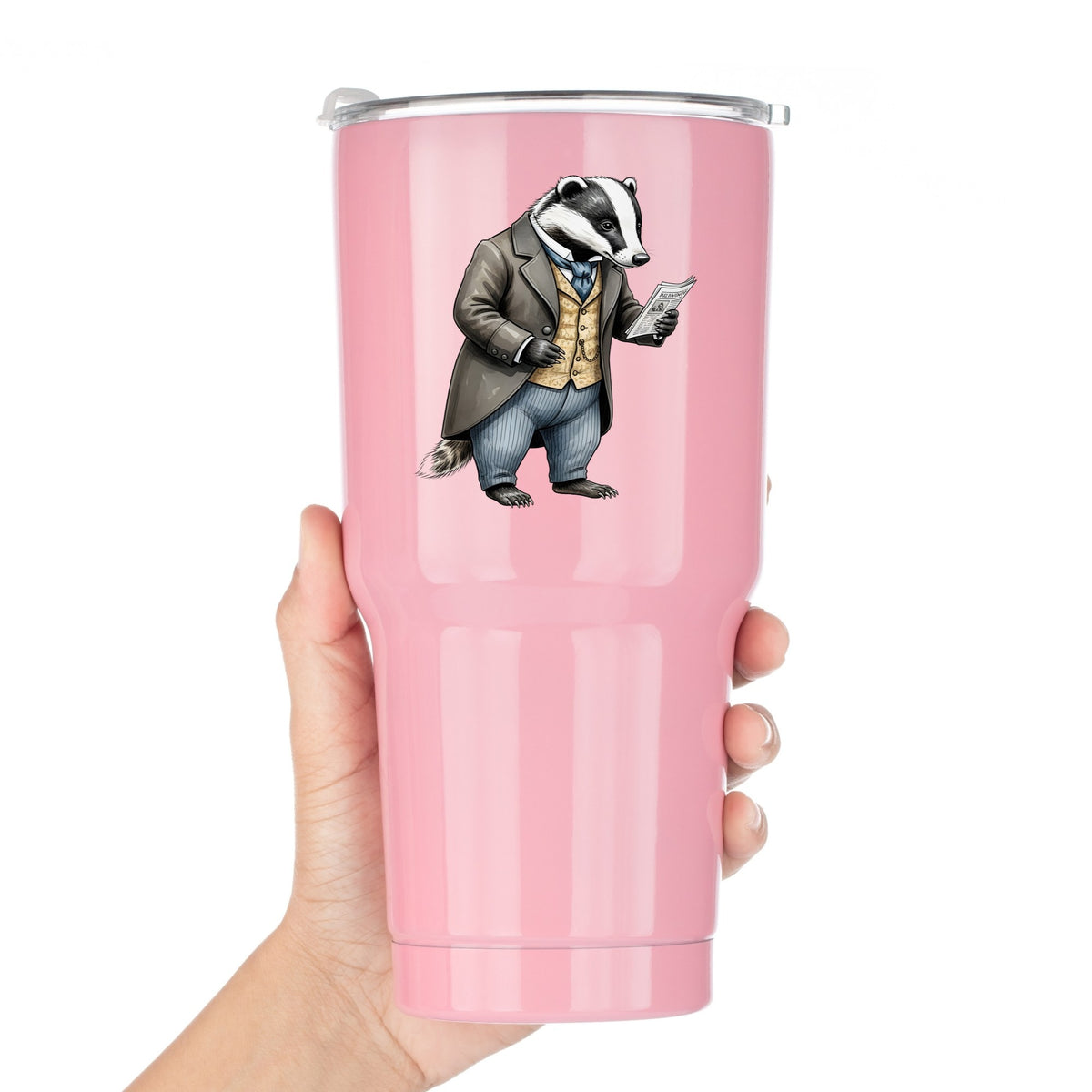 Badger Reading Newspaper UV DTF sticker applied to a pink tumbler held against a white background