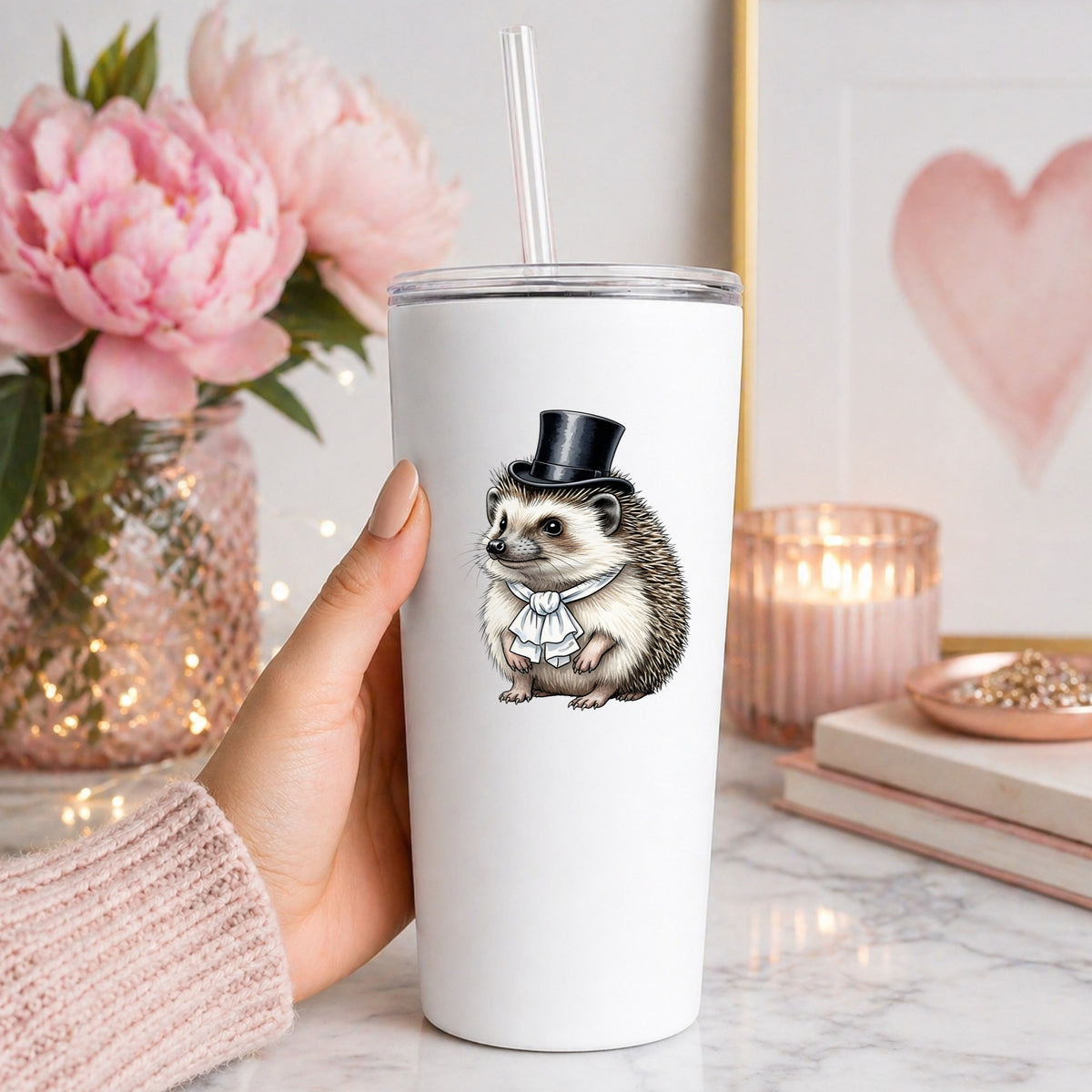 Hedgehog In Top Hat UV DTF sticker applied to a white straw tumbler beside pink peonies
