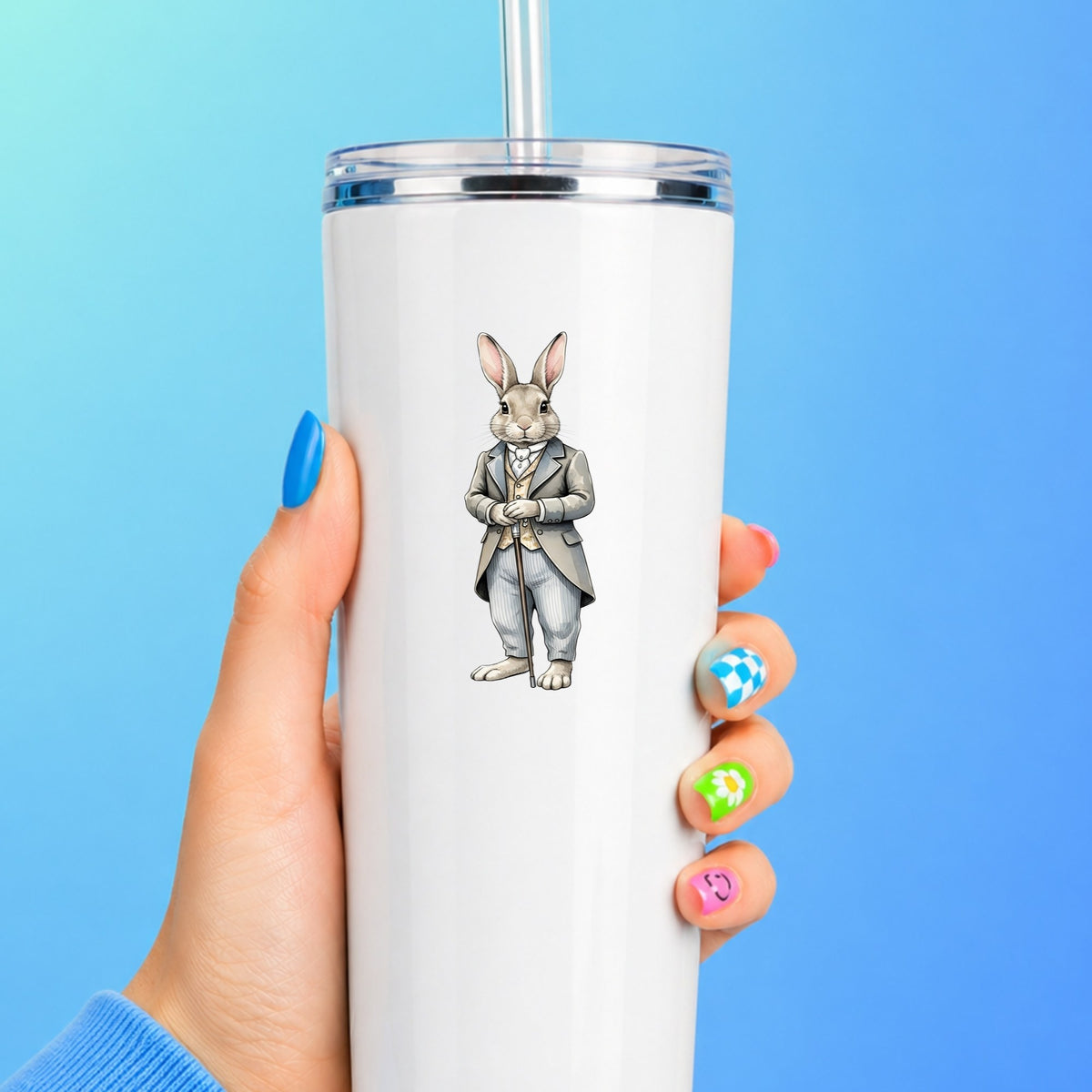 Gray Bunny Victorian Suit Cane UV DTF sticker applied to a white straw tumbler on a blue background
