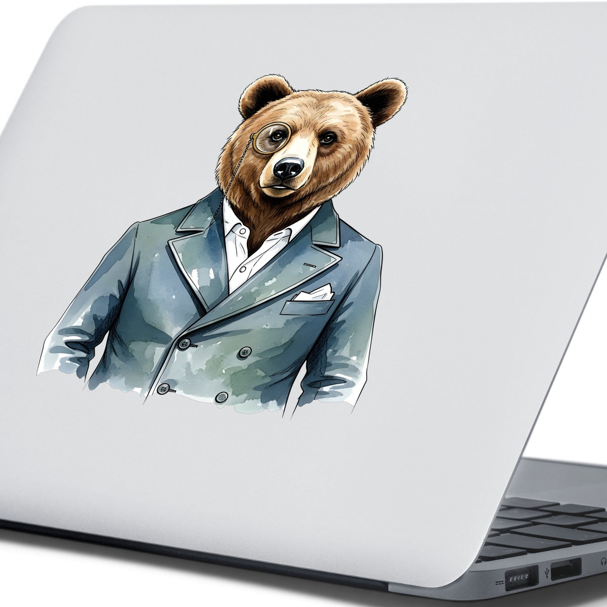 Bear With Monocle Blue Suit UV DTF sticker applied to the lid of a silver laptop
