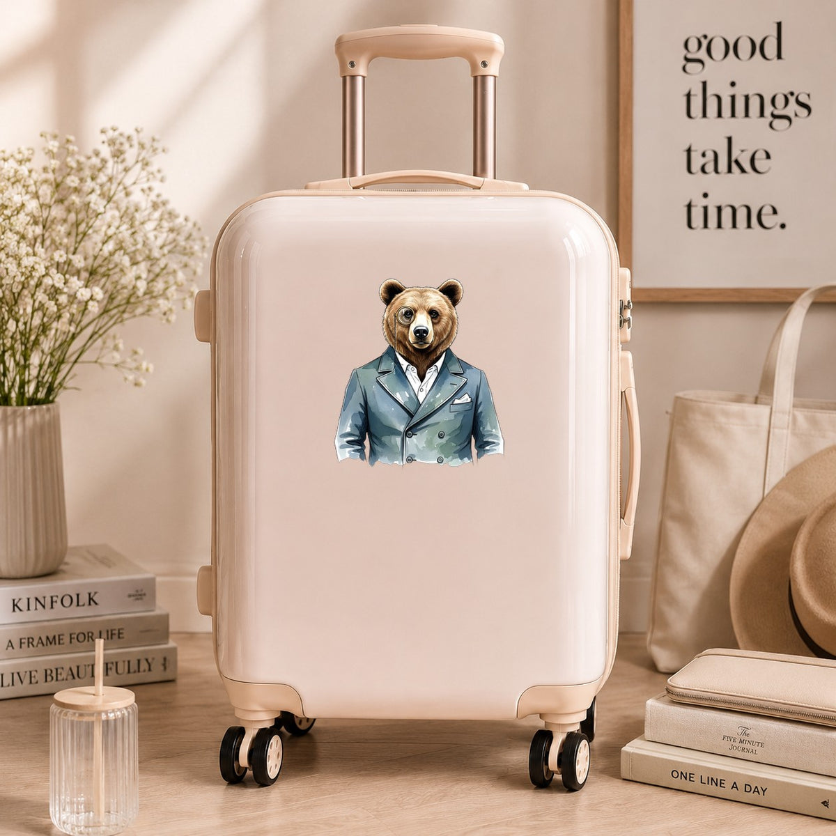 Bear With Monocle Blue Suit UV DTF sticker applied to a cream carry-on suitcase