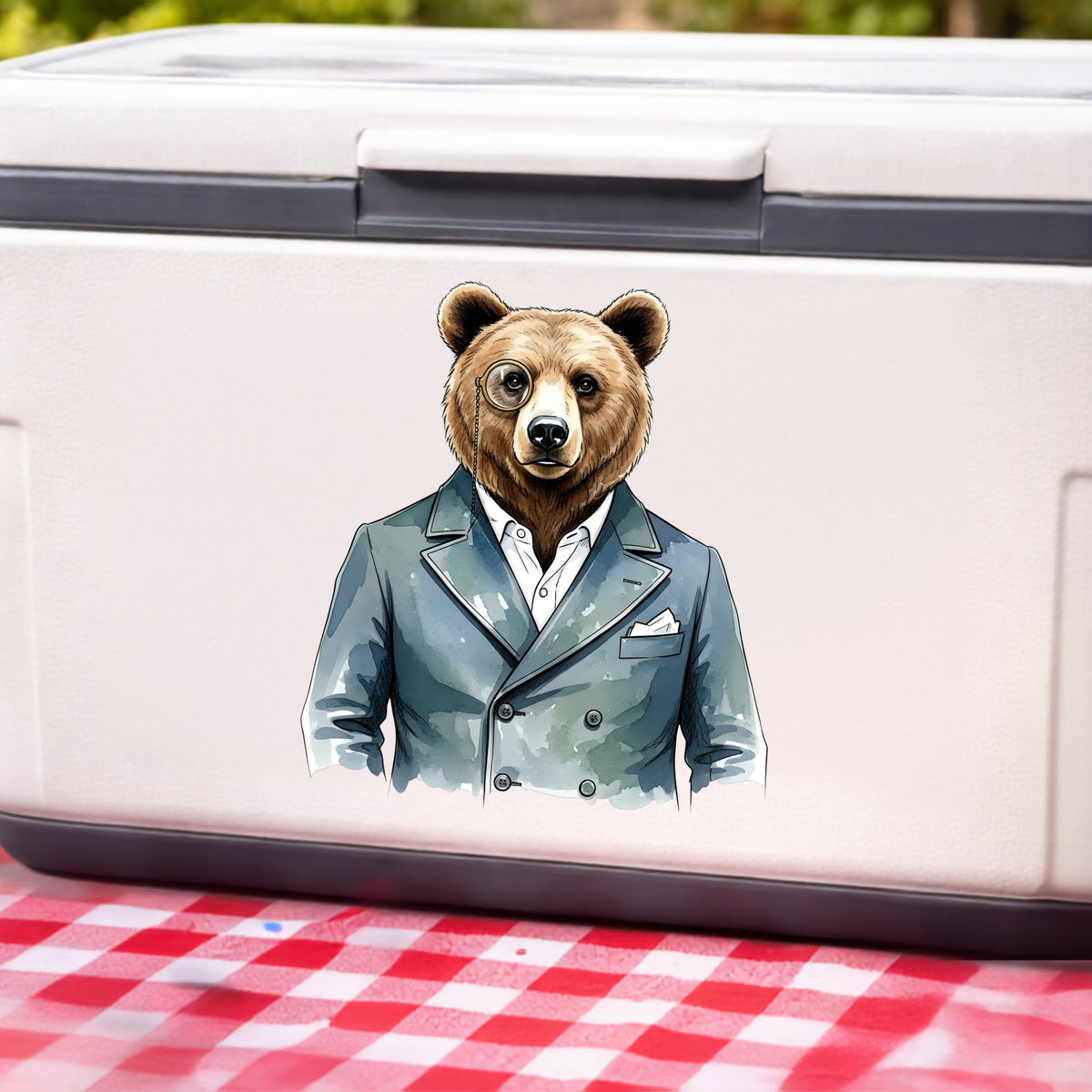 Bear With Monocle Blue Suit UV DTF sticker applied to a white cooler on a red gingham cloth