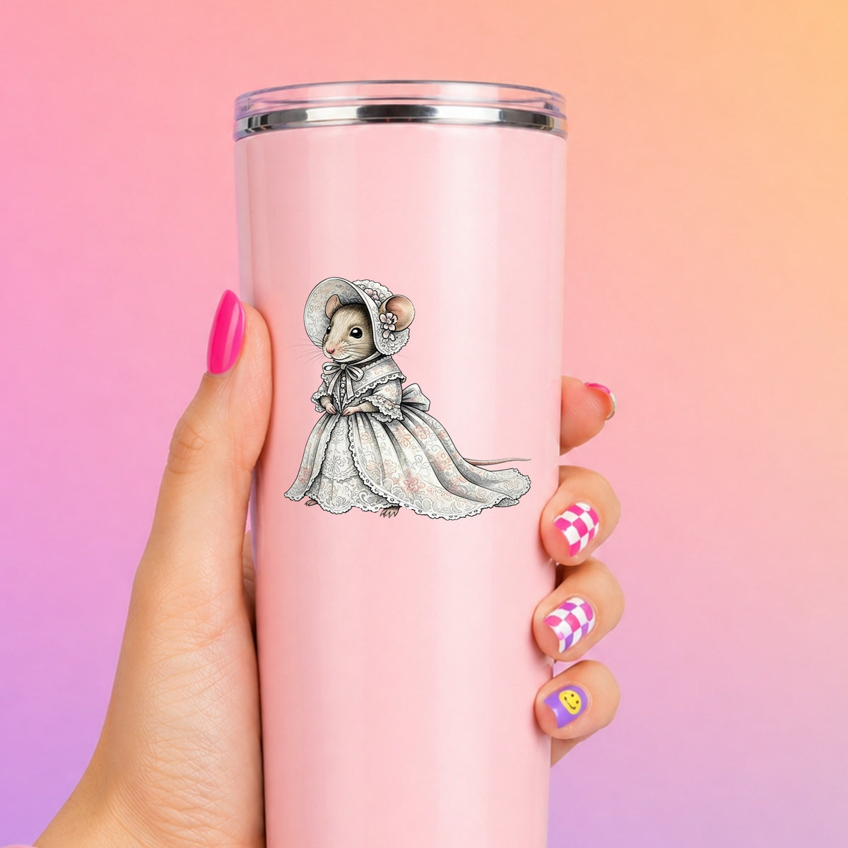 Mouse In Lace Bonnet Dress UV DTF sticker applied to a tall pink tumbler on a pink and orange background