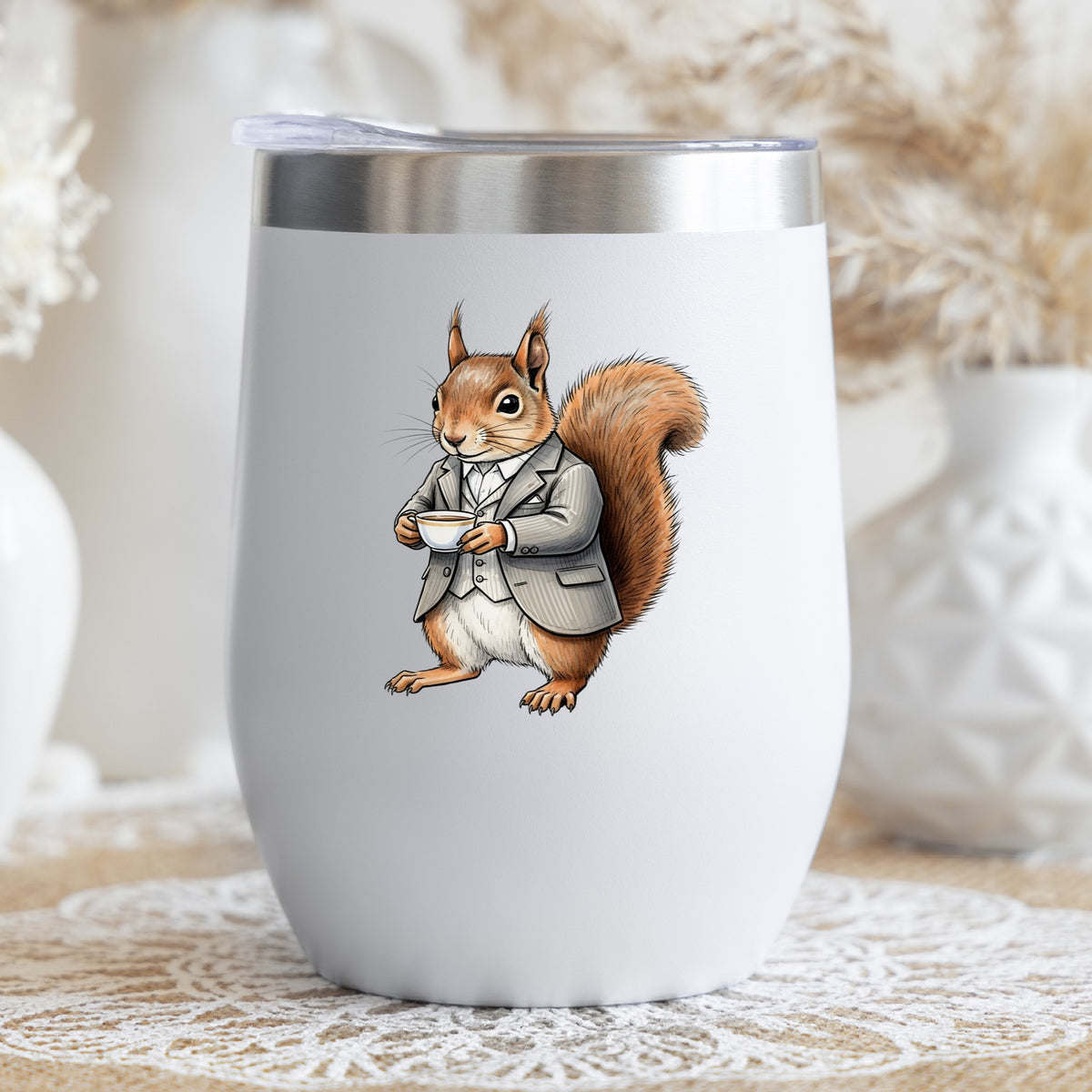Red Squirrel Holding Teacup UV DTF sticker applied to a white stemless tumbler with a lid