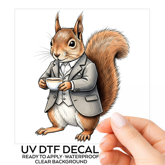 Red Squirrel Holding Teacup UV DTF sticker on its backing card, held in hand