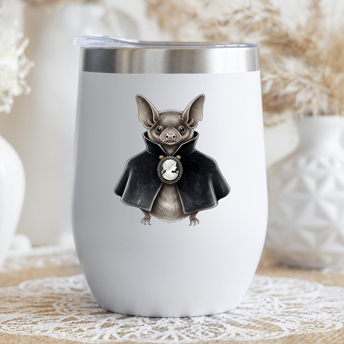 Bat In Black Cape Cameo UV DTF sticker applied to a white stemless tumbler with a lid