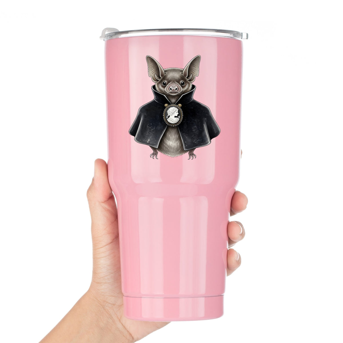 Bat In Black Cape Cameo UV DTF sticker applied to a pink tumbler held against a white background