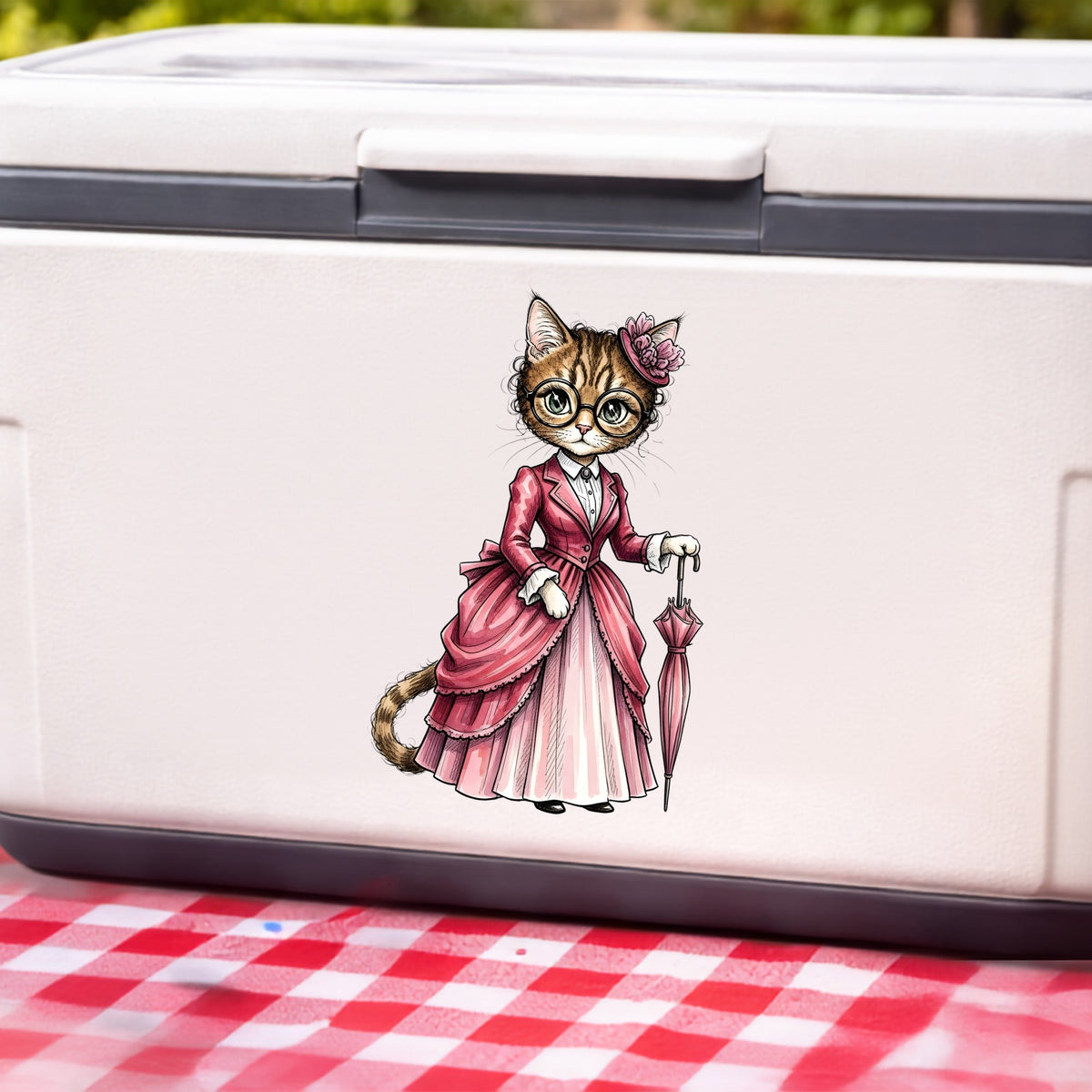 Tabby Cat Pink Victorian Dress UV DTF sticker applied to a white cooler on a red gingham cloth