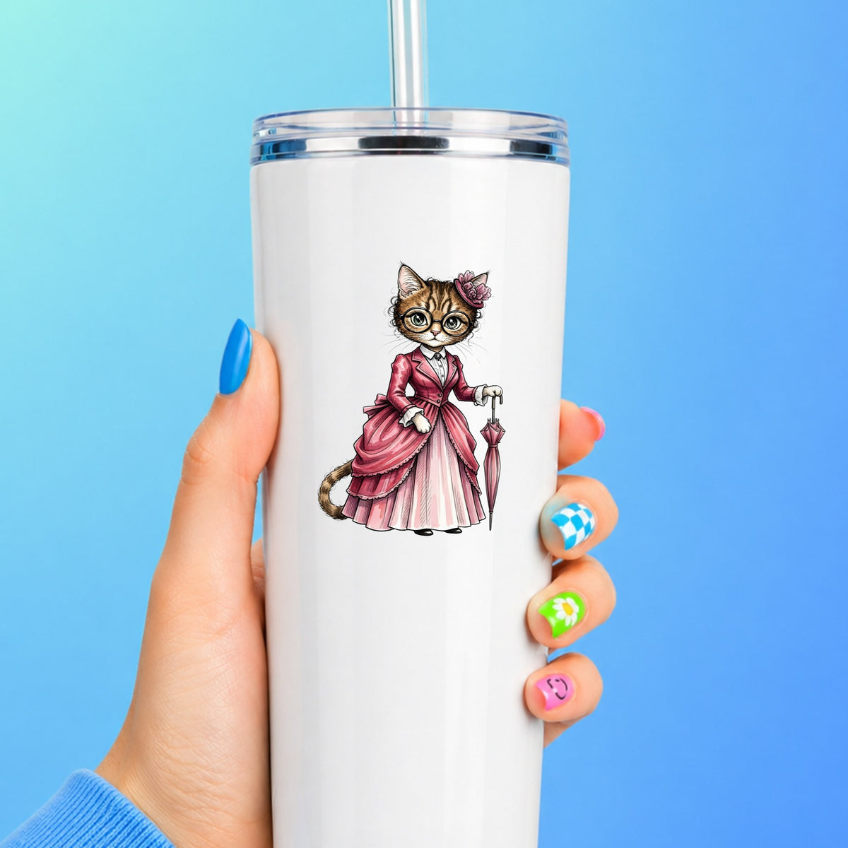 Tabby Cat Pink Victorian Dress UV DTF sticker applied to a white straw tumbler on a blue background