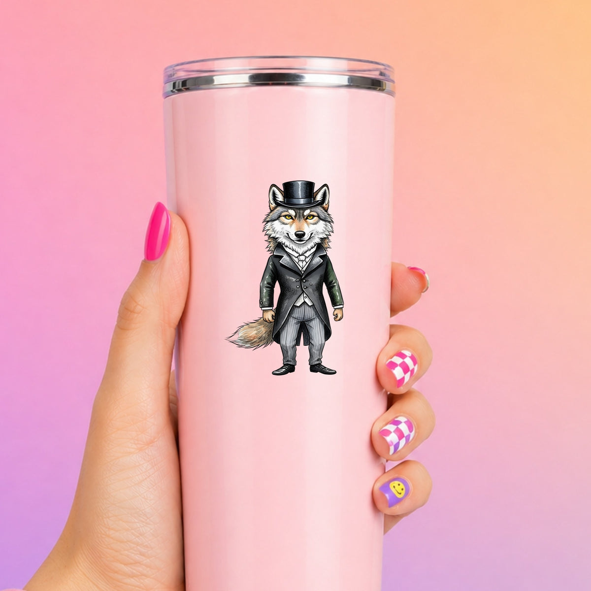 Gray Wolf Top Hat Tailcoat UV DTF sticker applied to a tall pink tumbler on a pink and orange background