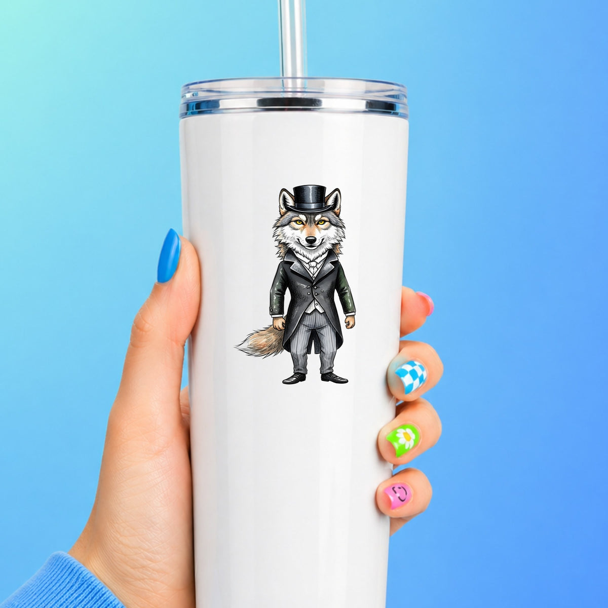 Gray Wolf Top Hat Tailcoat UV DTF sticker applied to a white straw tumbler on a blue background