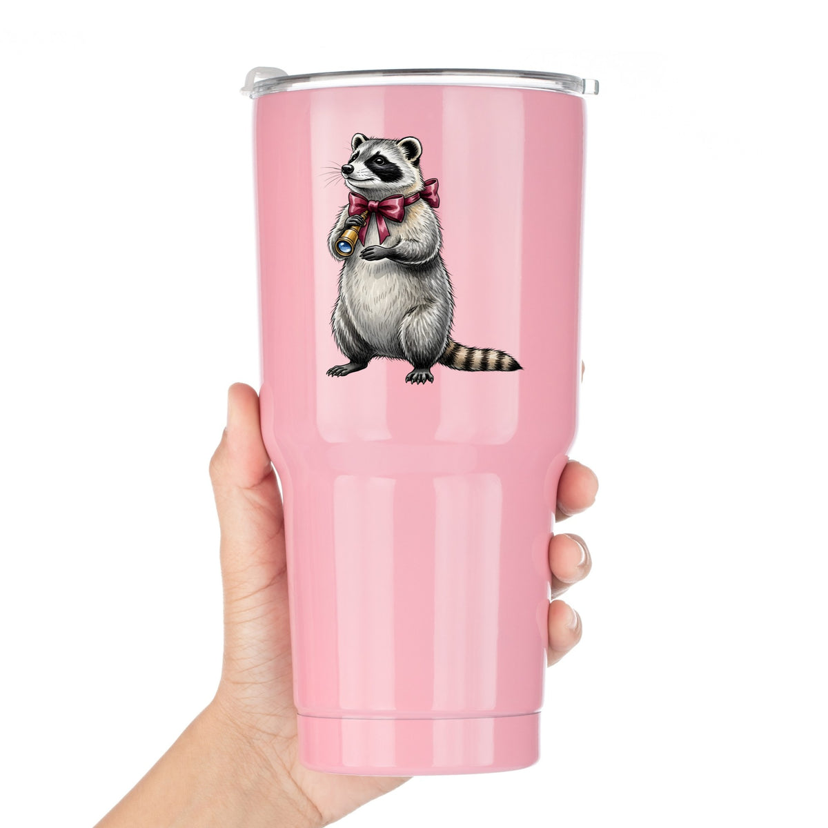 Raccoon With Spyglass Red Bow UV DTF sticker applied to a pink tumbler held against a white background