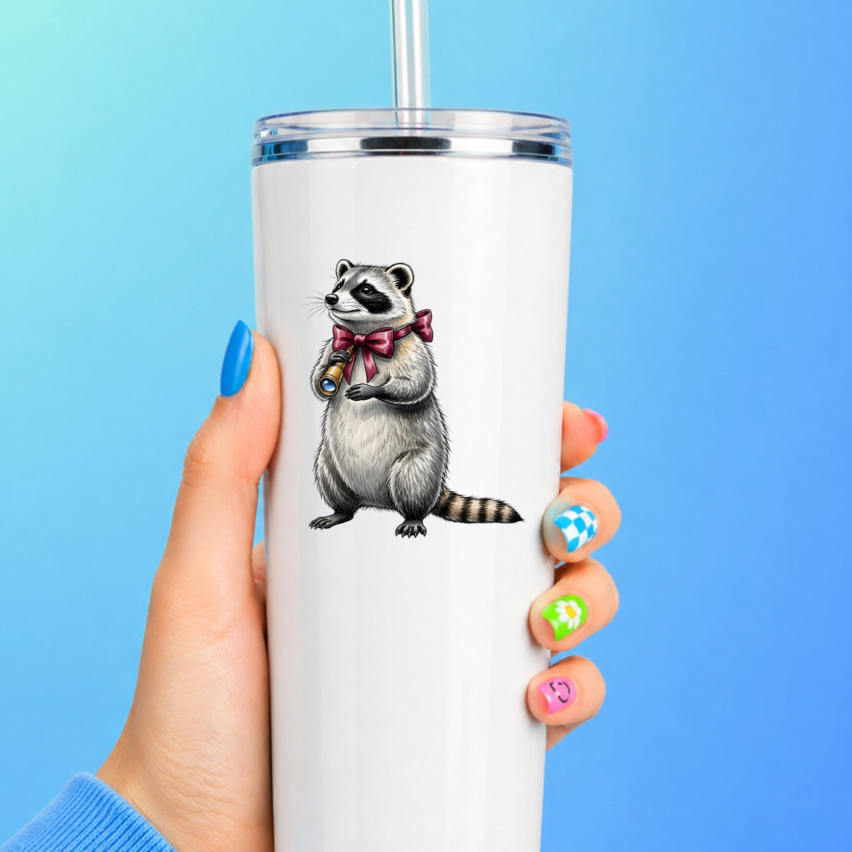 Raccoon With Spyglass Red Bow UV DTF sticker applied to a white straw tumbler on a blue background