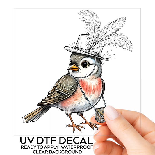 Fancy Bird Feather Hat Purse UV DTF sticker on its backing card, held in hand