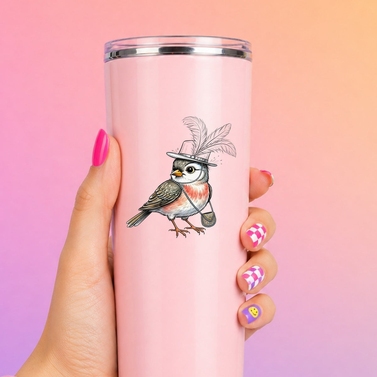 Fancy Bird Feather Hat Purse UV DTF sticker applied to a tall pink tumbler on a pink and orange background