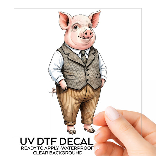 Pig In Tweed Vest UV DTF sticker on its backing card, held in hand