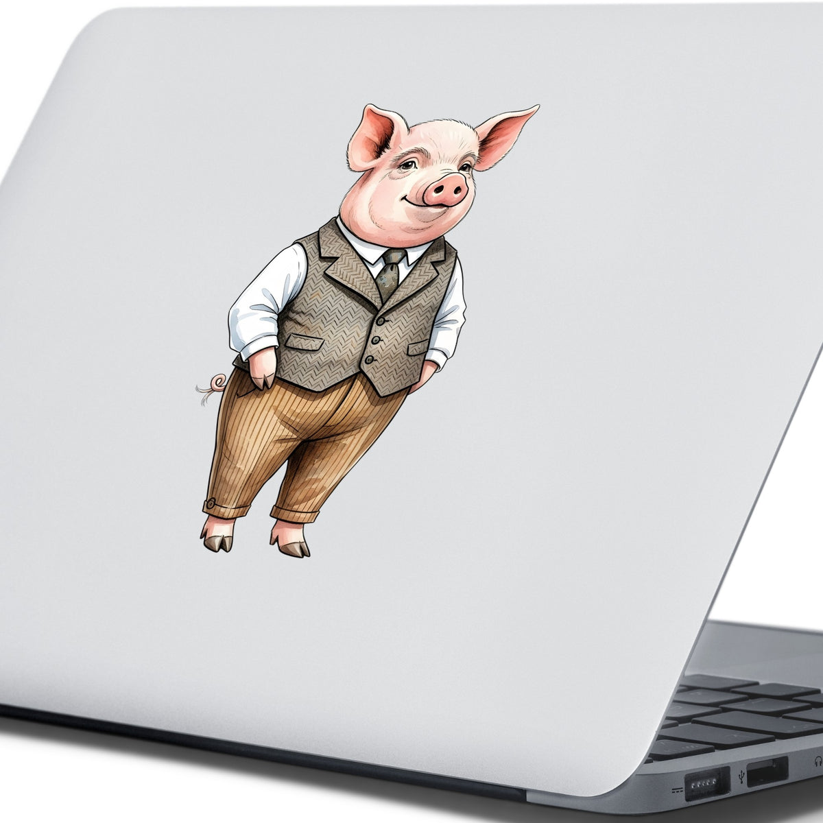 Pig In Tweed Vest UV DTF sticker applied to the lid of a silver laptop