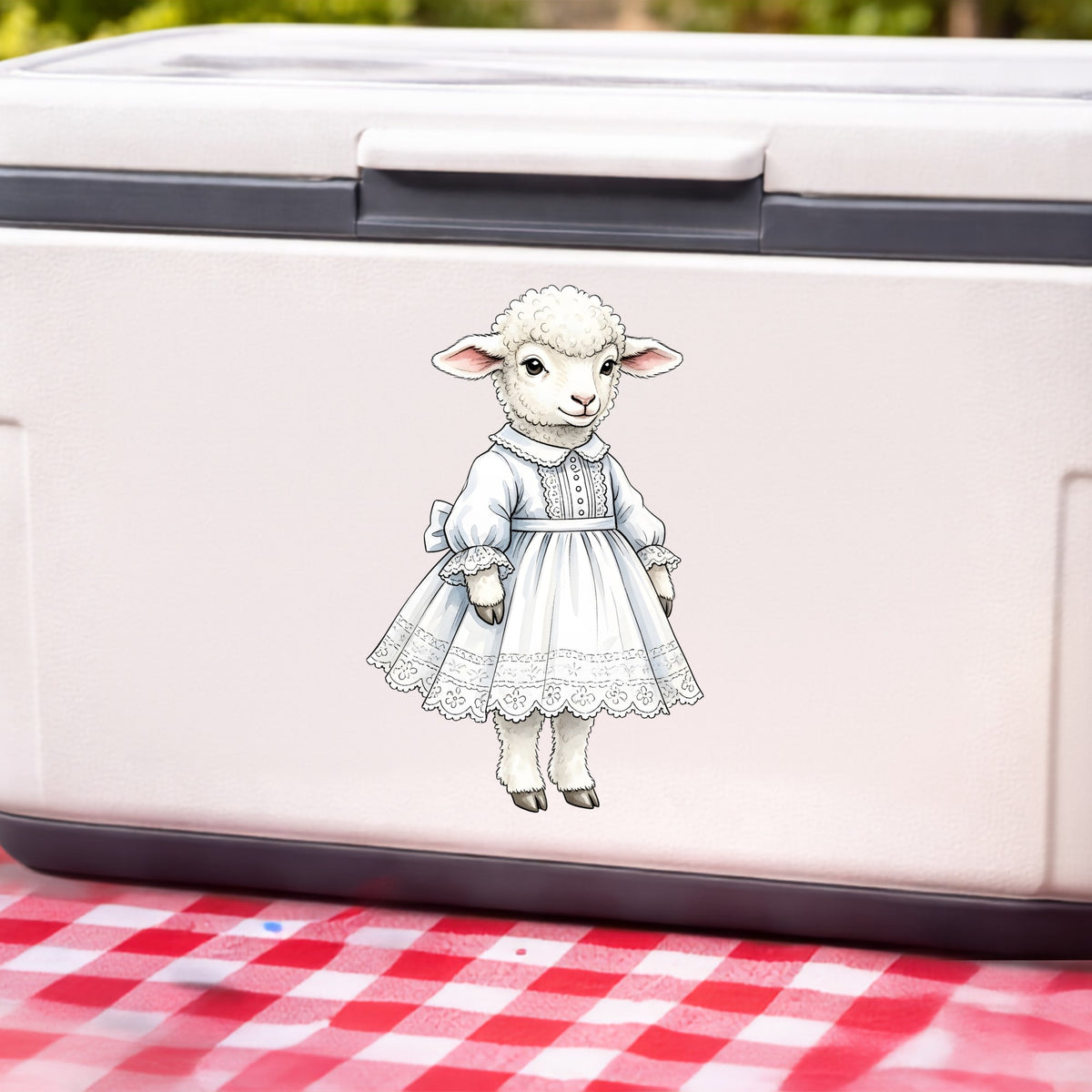 Lamb In White Lace Dress UV DTF sticker applied to a white cooler on a red gingham cloth
