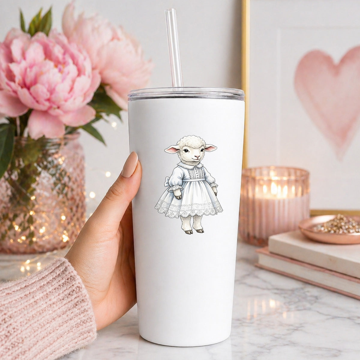 Lamb In White Lace Dress UV DTF sticker applied to a white straw tumbler beside pink peonies