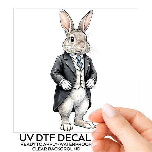 Rabbit Black Tailcoat Blue Tie UV DTF sticker on its backing card, held in hand