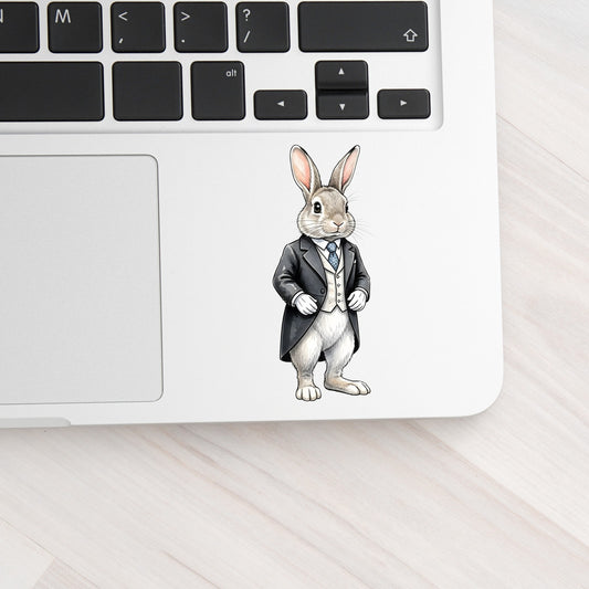 Rabbit Black Tailcoat Blue Tie UV DTF sticker applied to a silver laptop beside the keyboard