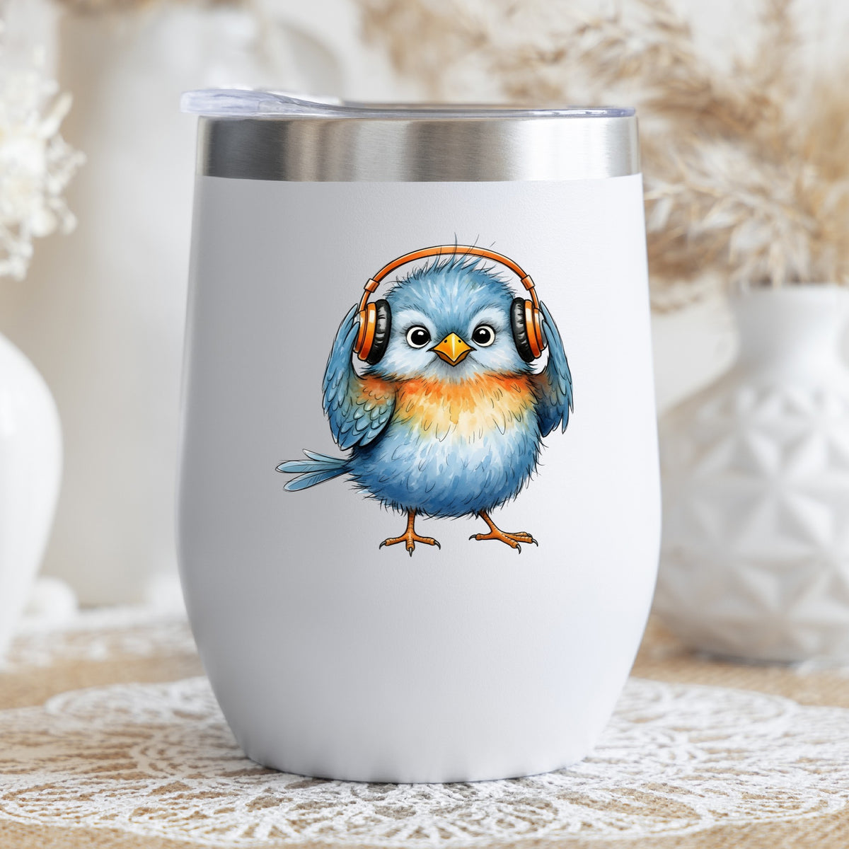Blue Bird With Headphones UV DTF sticker applied to a white stemless tumbler with a lid