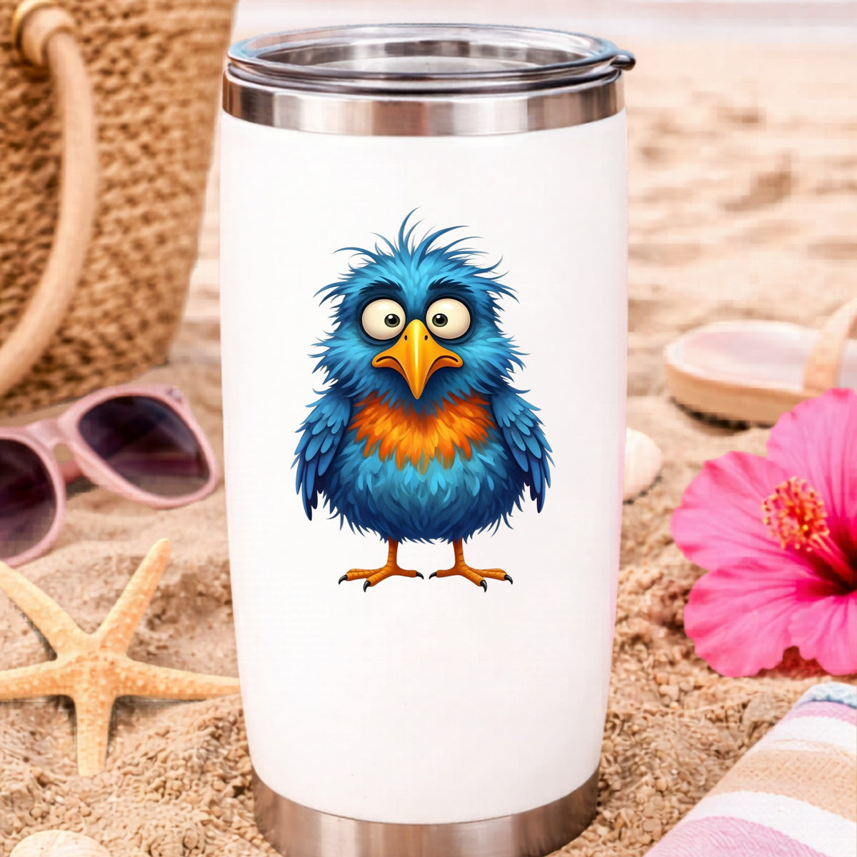 Wide Eyed Shaggy Blue Bird UV DTF sticker applied to a white travel tumbler on beach sand