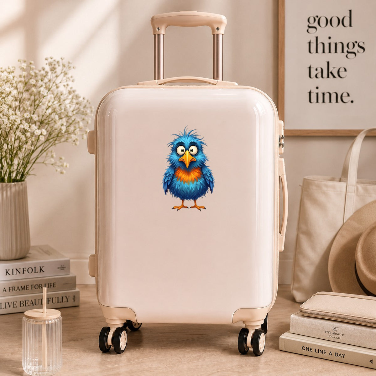Wide Eyed Shaggy Blue Bird UV DTF sticker applied to a cream carry-on suitcase