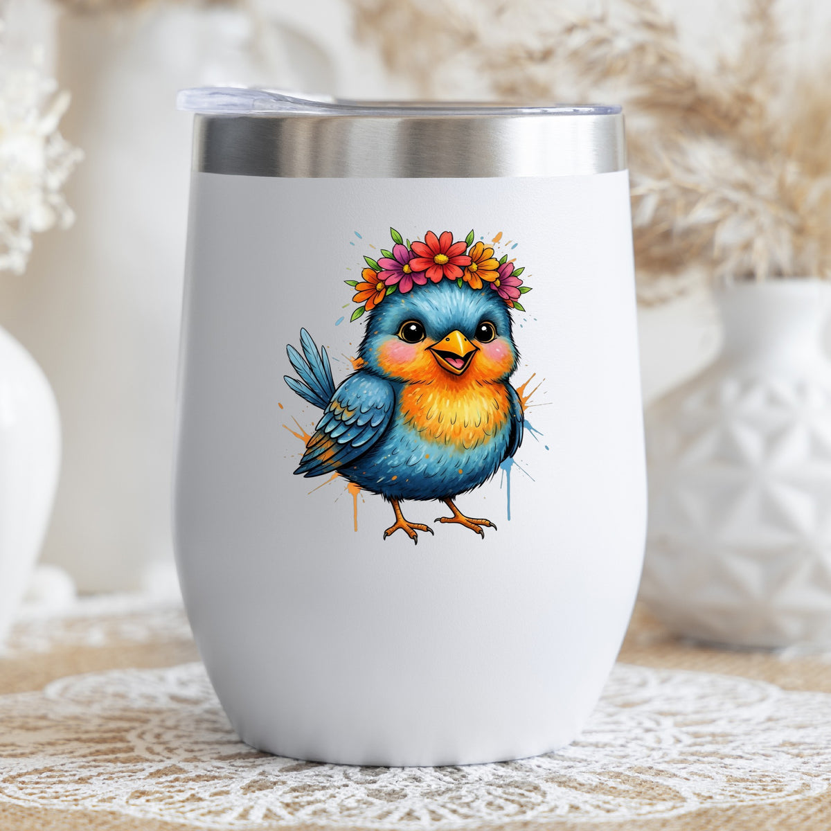 Flower Crown Blue Bird UV DTF sticker applied to a white stemless tumbler with a lid
