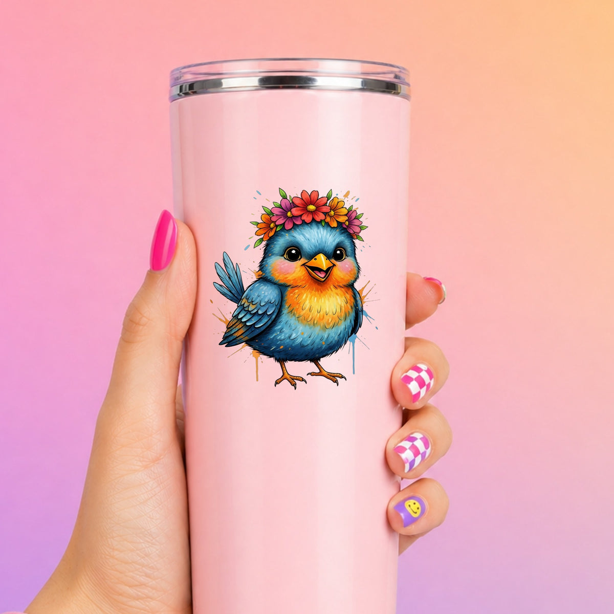 Flower Crown Blue Bird UV DTF sticker applied to a tall pink tumbler on a pink and orange background