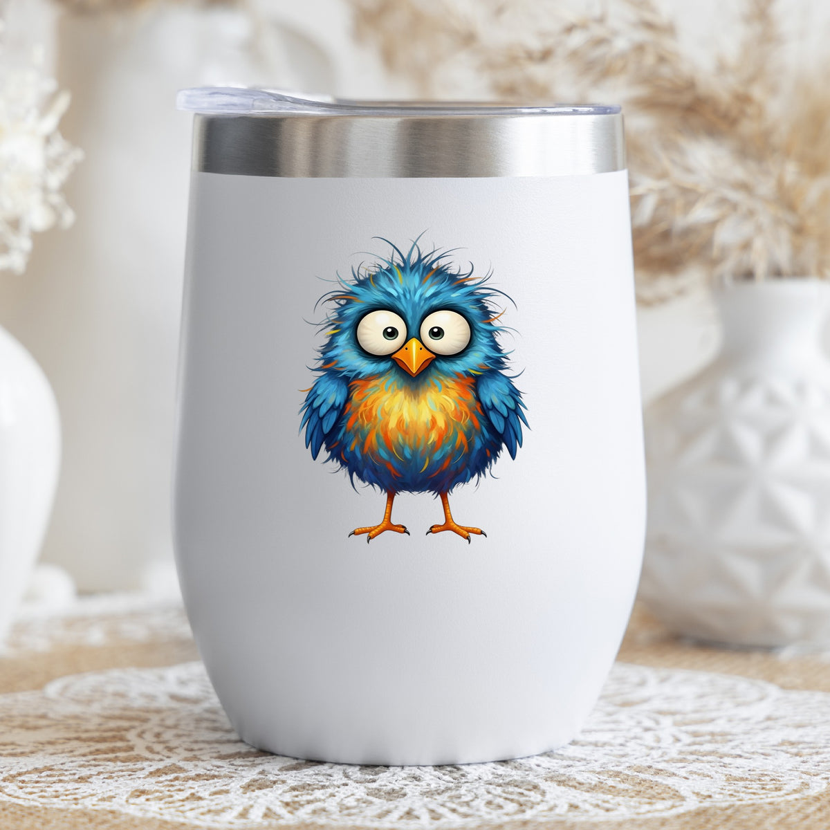 Chaotic Fuzzy Blue Bird UV DTF sticker applied to a white stemless tumbler with a lid