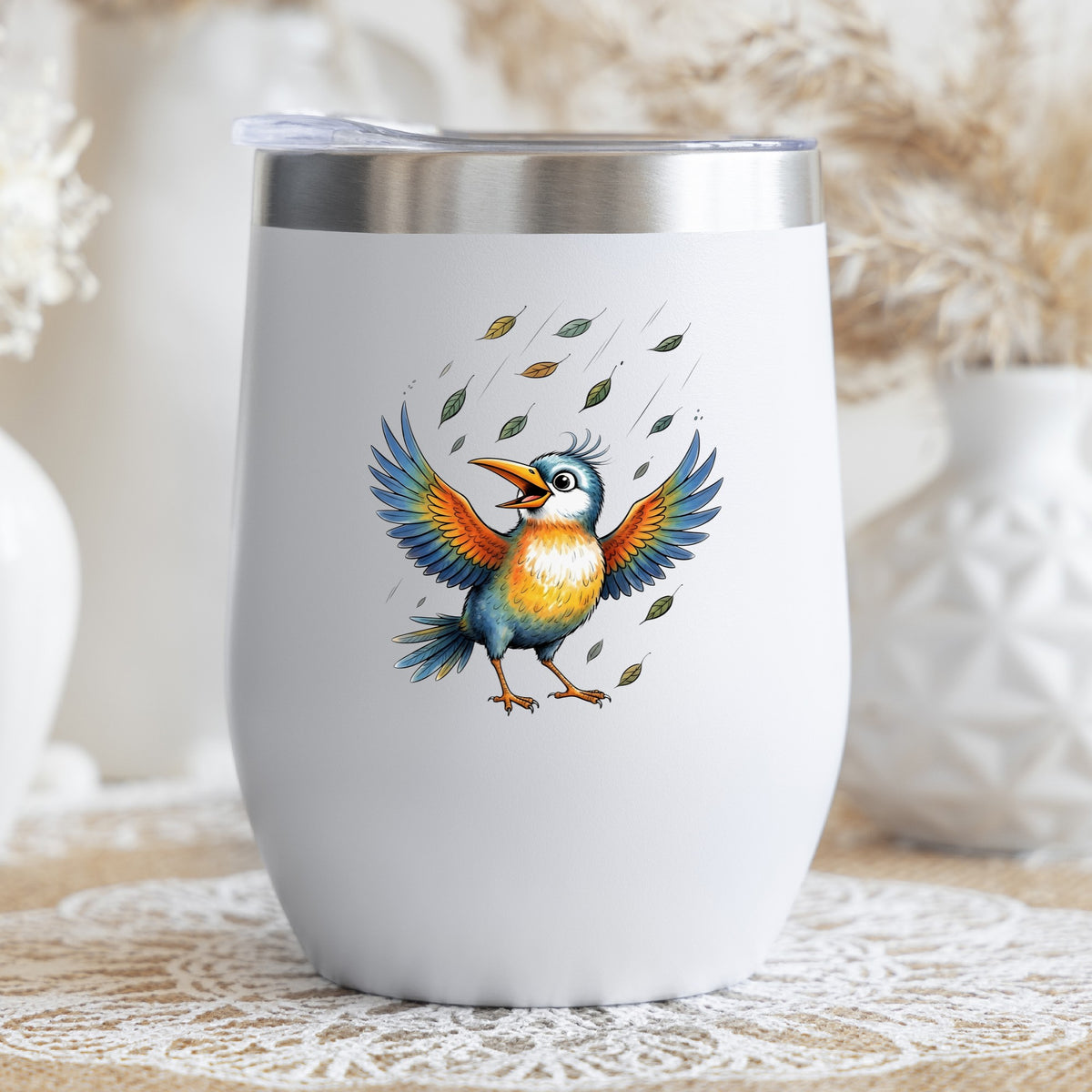 Happy Bird Wings Spread Falling Leaves UV DTF sticker applied to a white stemless tumbler with a lid
