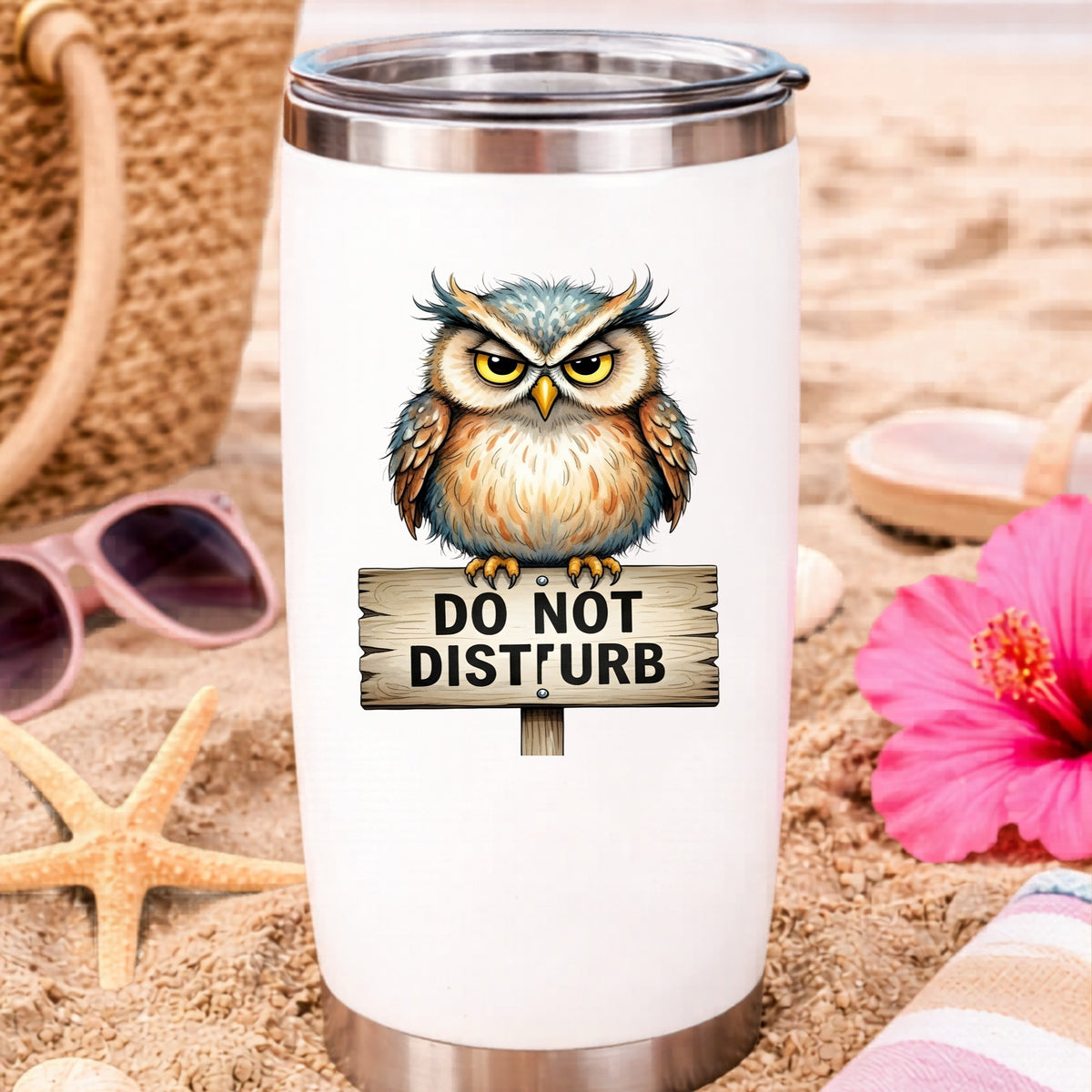 Grumpy Owl Do Not Disturb Sign UV DTF sticker applied to a white travel tumbler on beach sand
