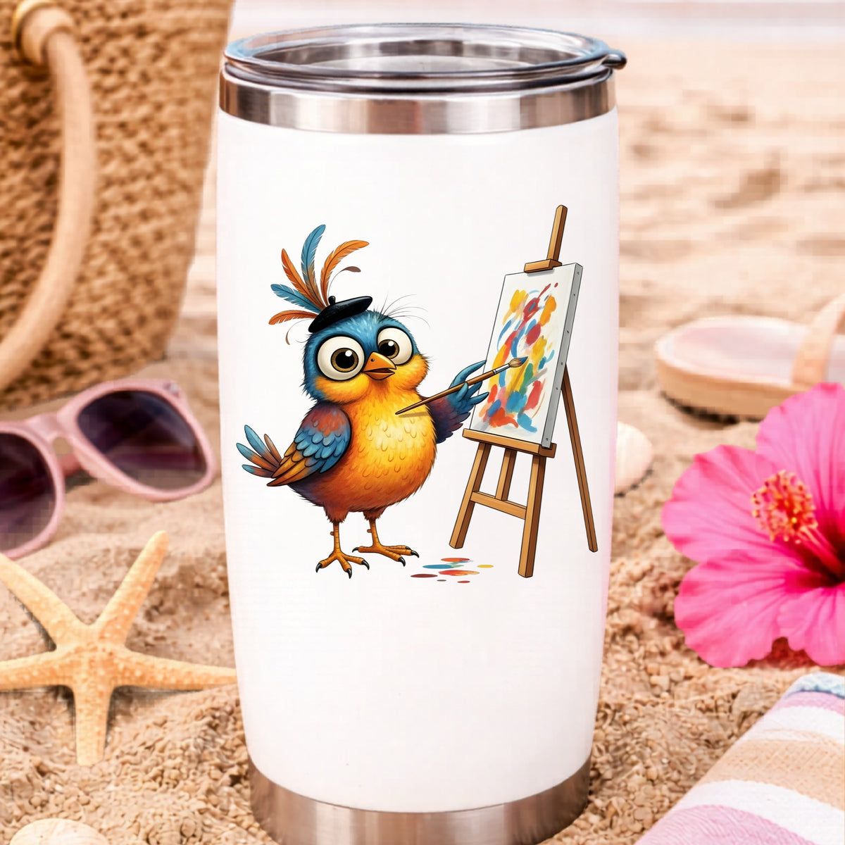Artist Bird Painting Easel Beret UV DTF sticker applied to a white travel tumbler on beach sand