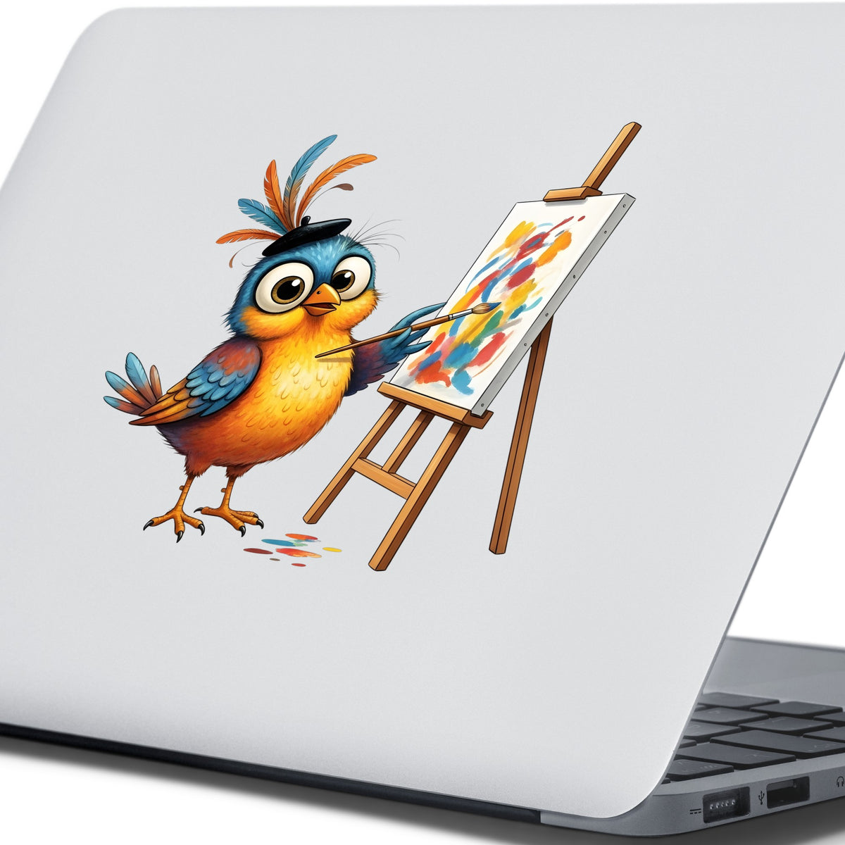 Artist Bird Painting Easel Beret UV DTF sticker applied to the lid of a silver laptop