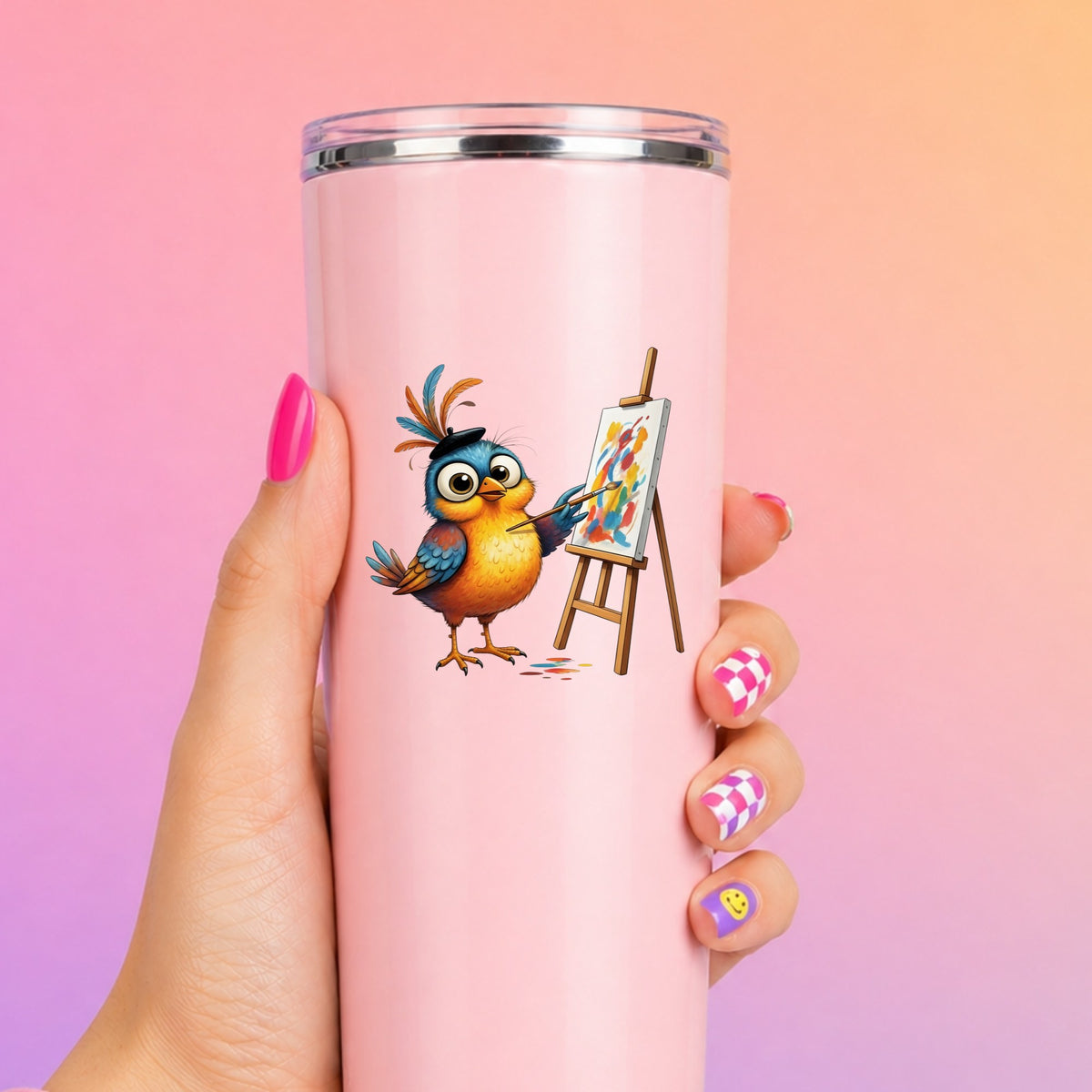 Artist Bird Painting Easel Beret UV DTF sticker applied to a tall pink tumbler on a pink and orange background