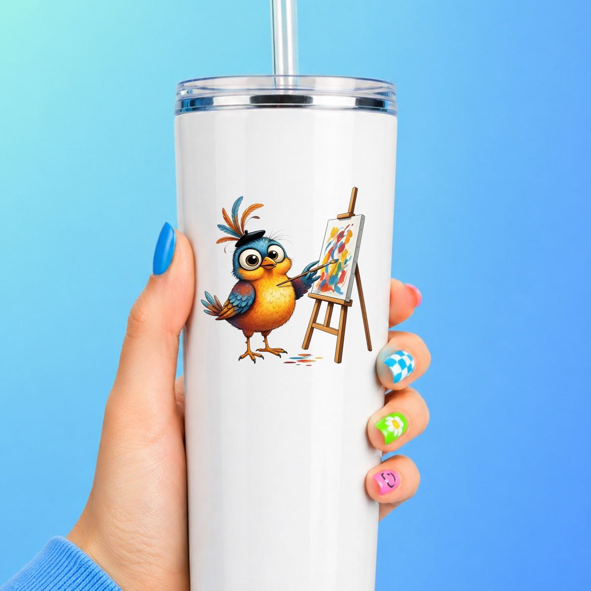Artist Bird Painting Easel Beret UV DTF sticker applied to a white straw tumbler on a blue background