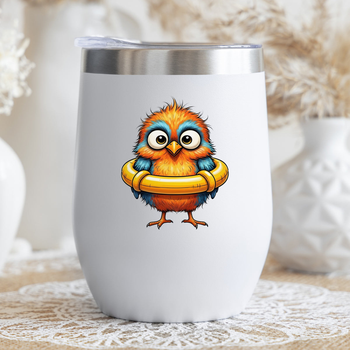 Orange Bird In Swim Ring UV DTF sticker applied to a white stemless tumbler with a lid