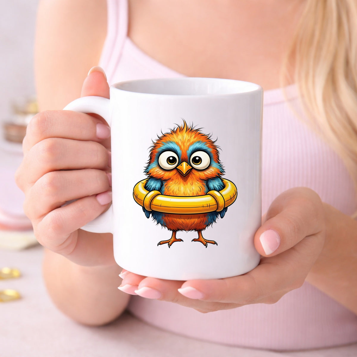 Orange Bird In Swim Ring UV DTF sticker applied to a white coffee mug held in both hands