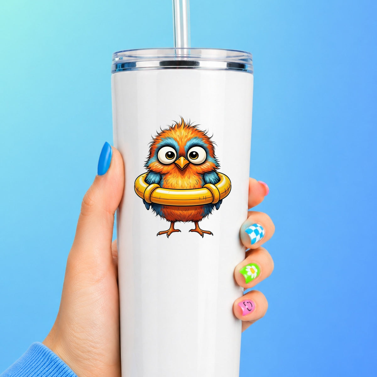 Orange Bird In Swim Ring UV DTF sticker applied to a white straw tumbler on a blue background