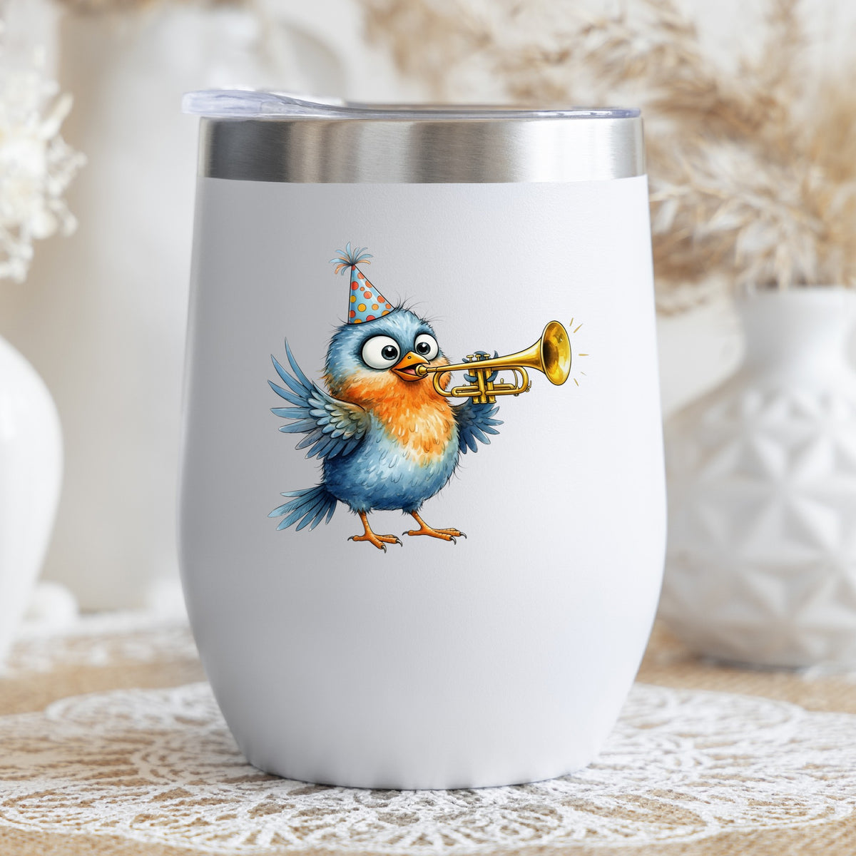 Party Hat Bird Trumpet UV DTF sticker applied to a white stemless tumbler with a lid