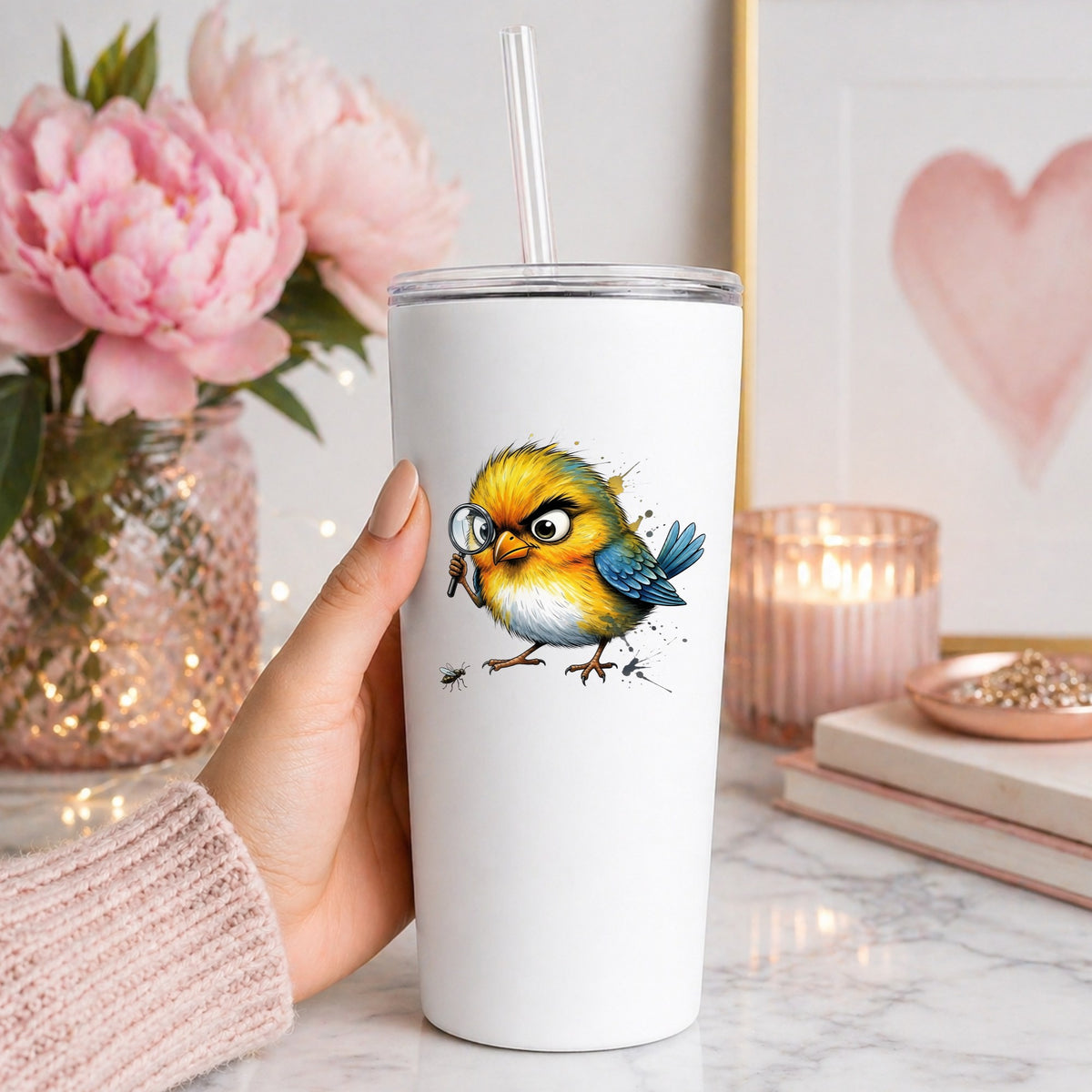 Yellow Bird Magnifying Glass Bug UV DTF sticker applied to a white straw tumbler beside pink peonies