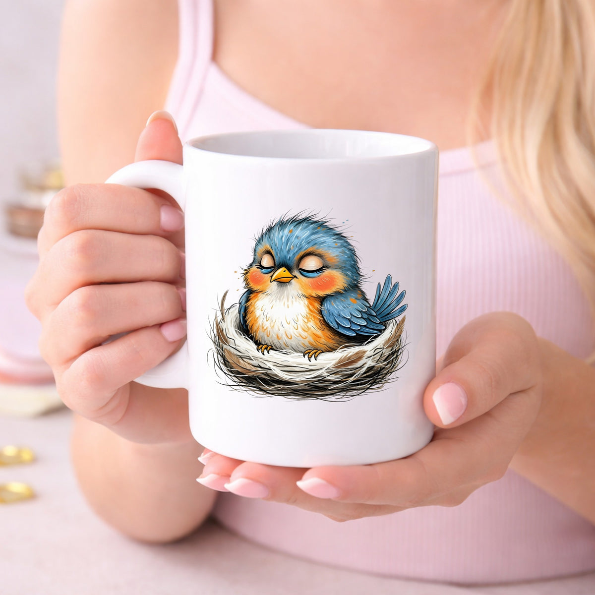 Sleeping Bird In Nest UV DTF sticker applied to a white coffee mug held in both hands
