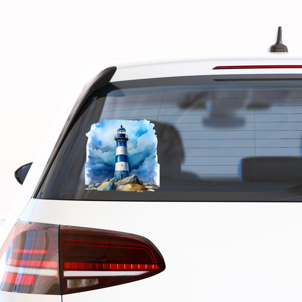 Blue Striped Lighthouse On Rocks UV DTF sticker applied to the rear window of a white car