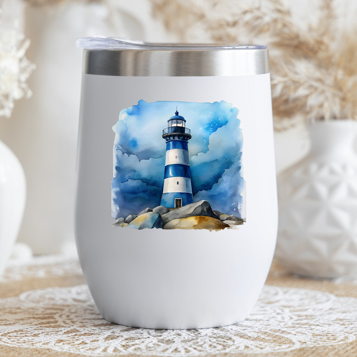 Blue Striped Lighthouse On Rocks UV DTF sticker applied to a white stemless tumbler with a lid