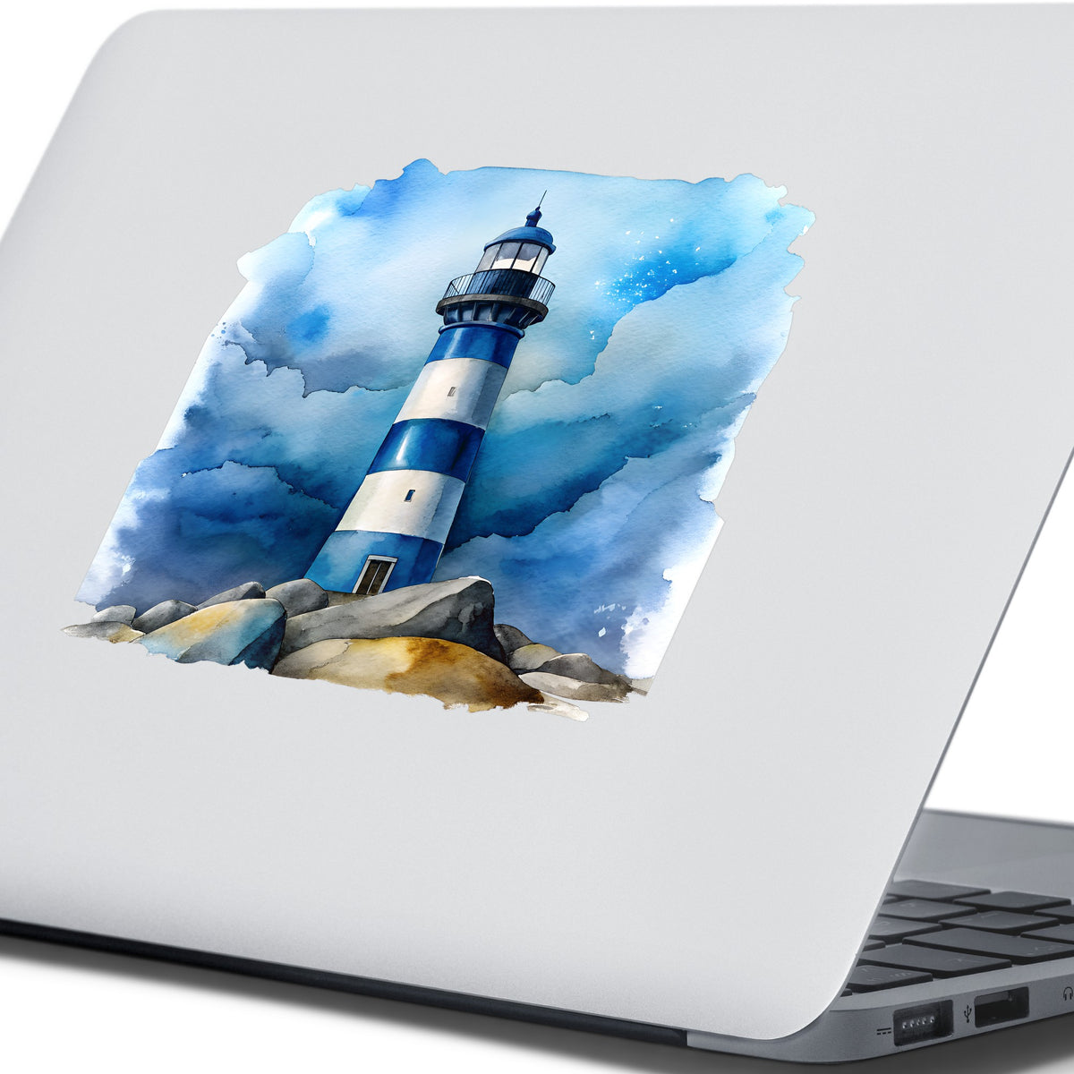 Blue Striped Lighthouse On Rocks UV DTF sticker applied to the lid of a silver laptop