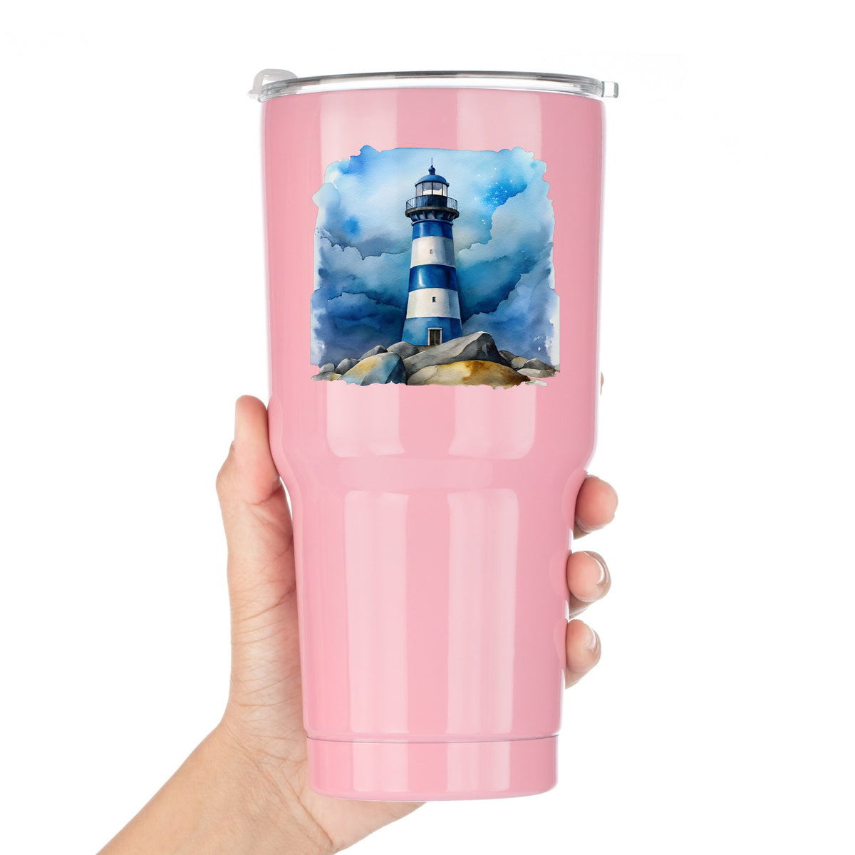 Blue Striped Lighthouse On Rocks UV DTF sticker applied to a pink tumbler held against a white background