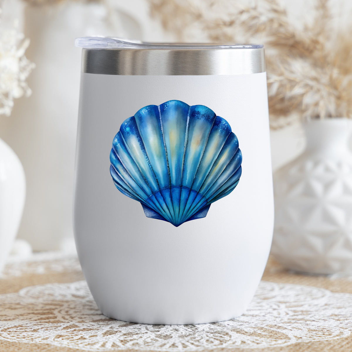 Blue Scallop Seashell UV DTF sticker applied to a white stemless tumbler with a lid