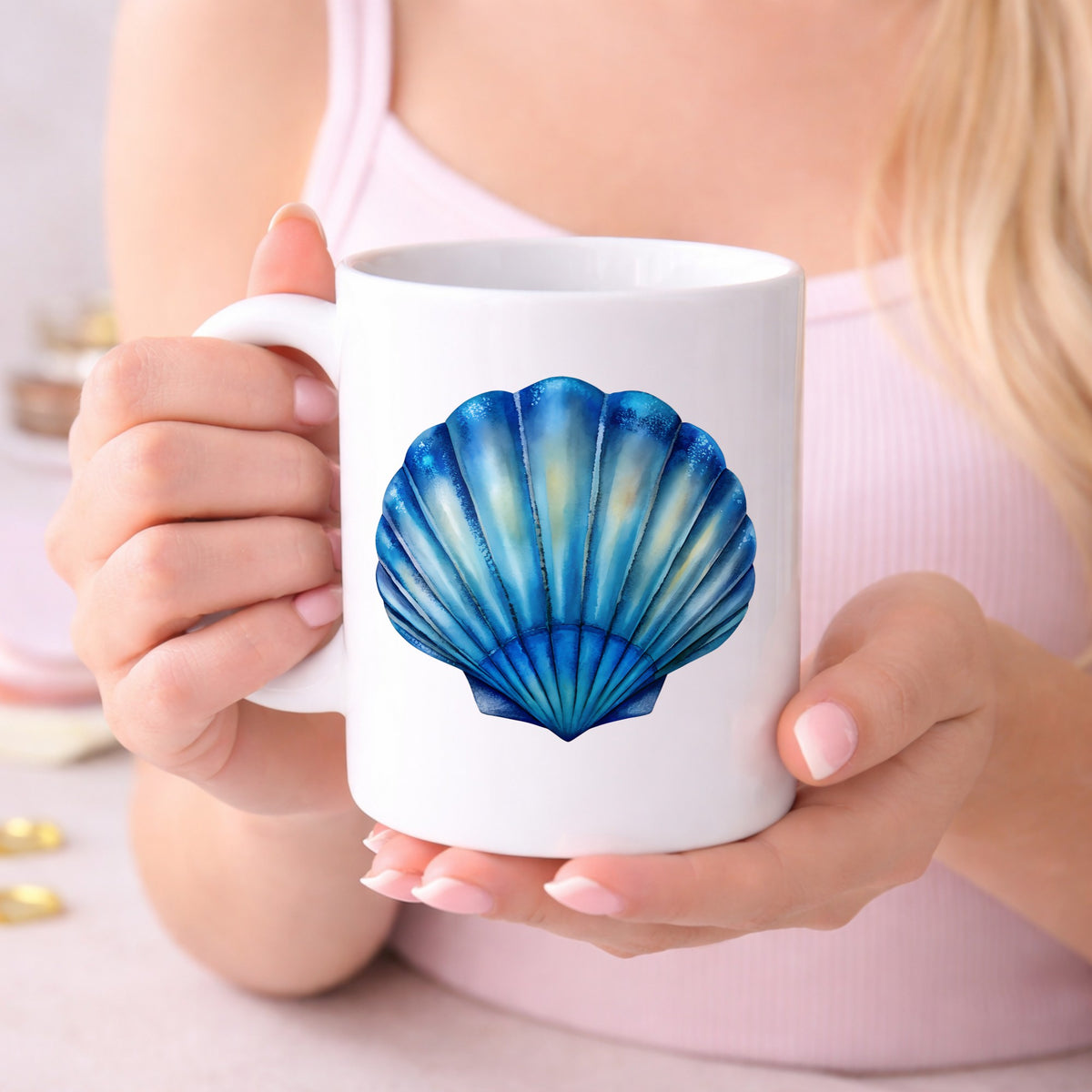 Blue Scallop Seashell UV DTF sticker applied to a white coffee mug held in both hands