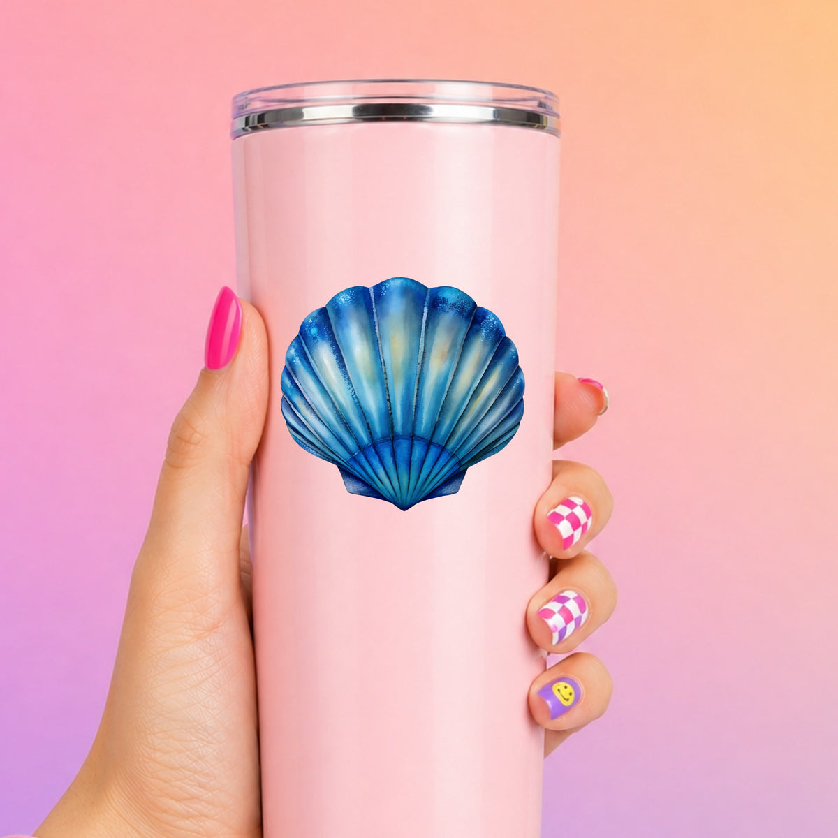 Blue Scallop Seashell UV DTF sticker applied to a tall pink tumbler on a pink and orange background